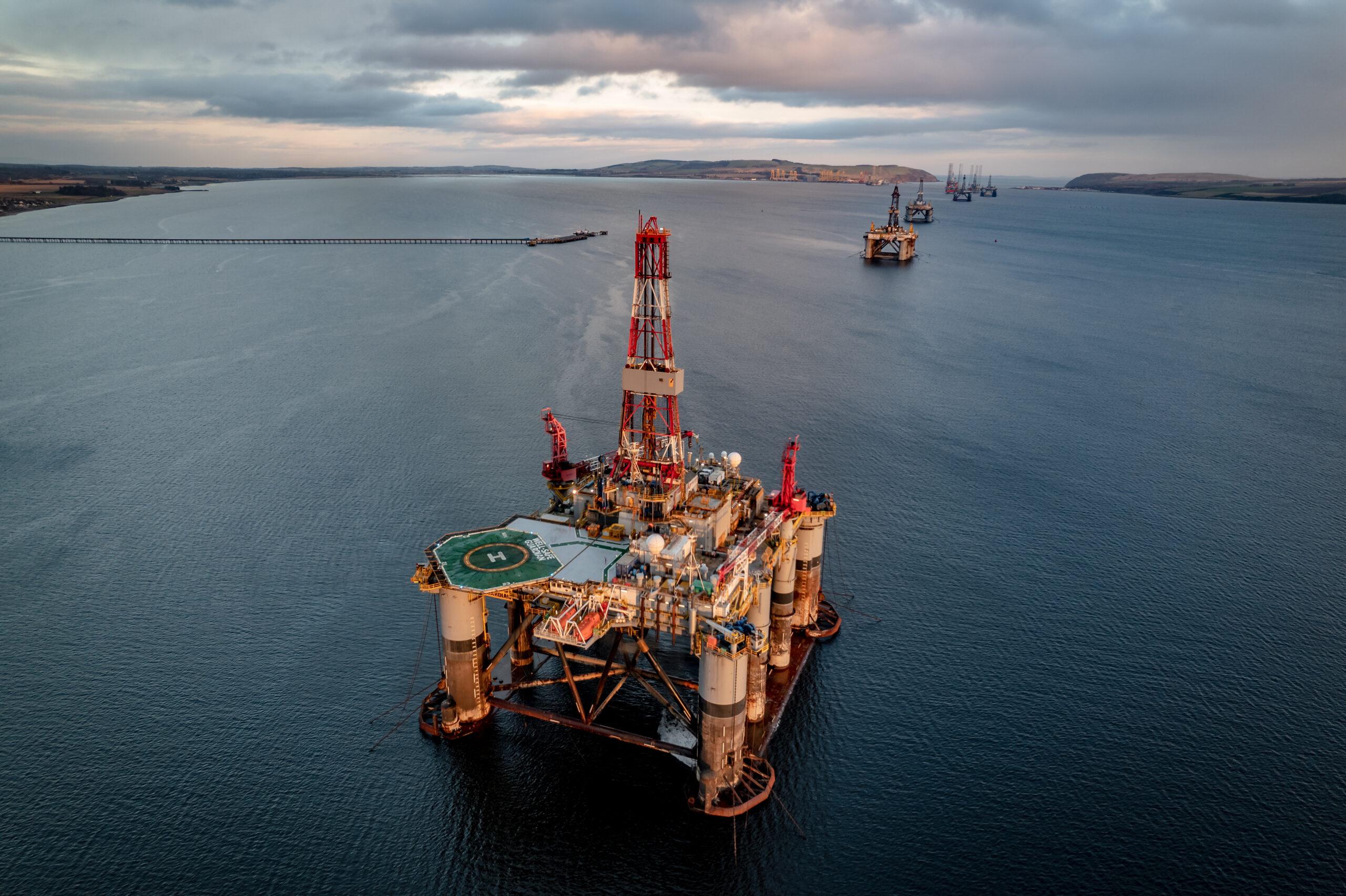 Blue Hour Oil and Gas Drilling Platform Oil rigs on a body of water.