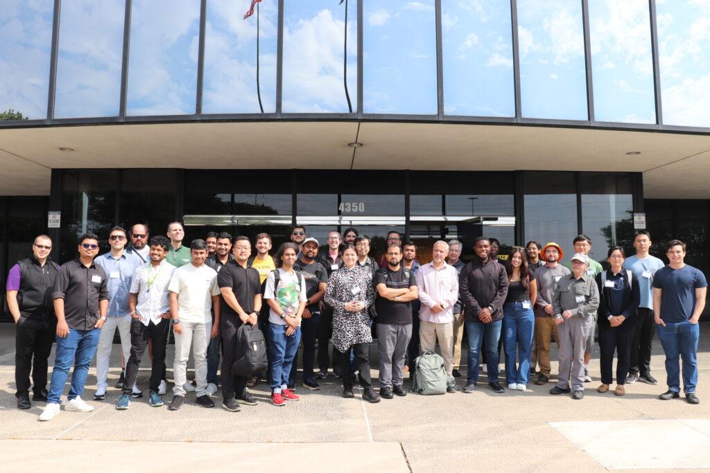 A group of a few dozen people pose for a group photo.