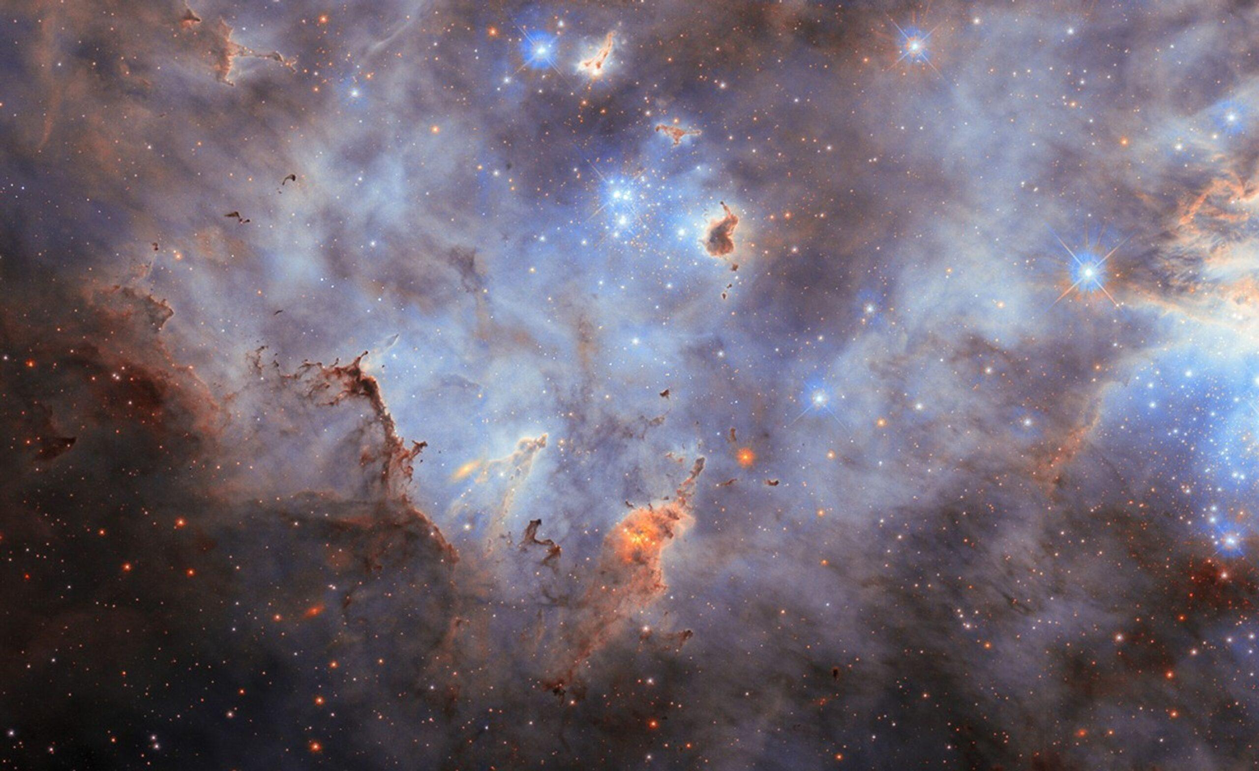 Hubble_LMC_N44C_potw2536a The nebula LMC N44C, showing a cloudy starscape from an impressive star cluster in the Large Magellanic Cloud.