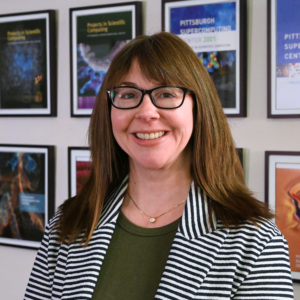 Portrait photo of a woman with light complexion and brown hair.