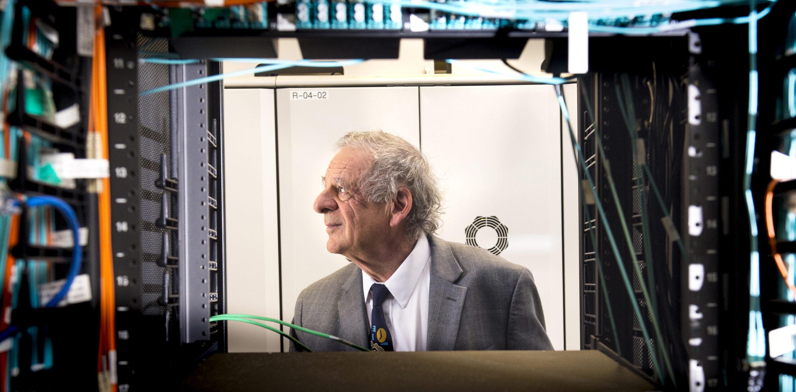 A portrait photo of a man as soon through computing components.