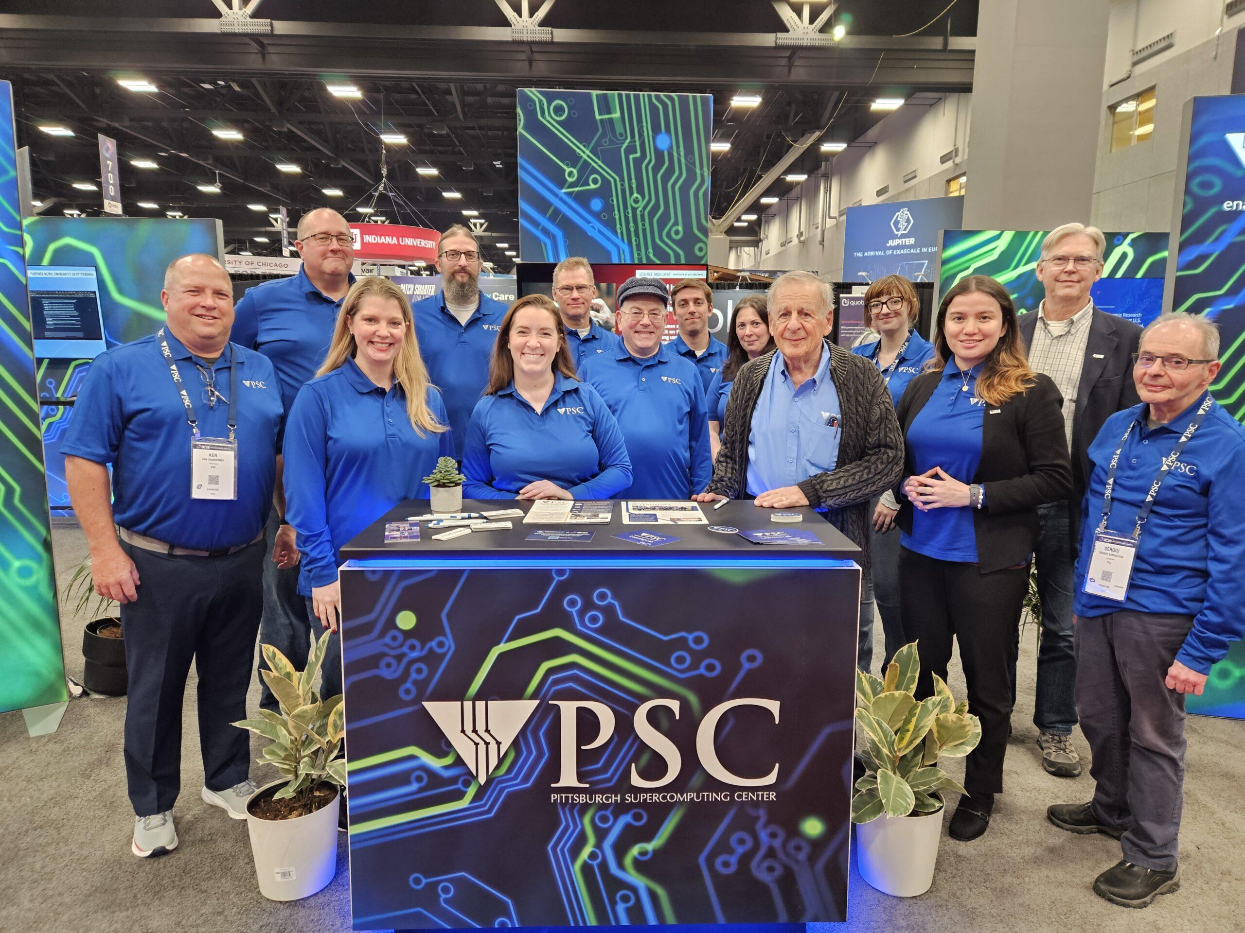 A group of PSC staff pose with Ralph at a conference.