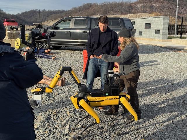 Rescue dummies are on the ground as researchers test a 4 legged robot from Boston Dynamics at a emergency rescue test site.
