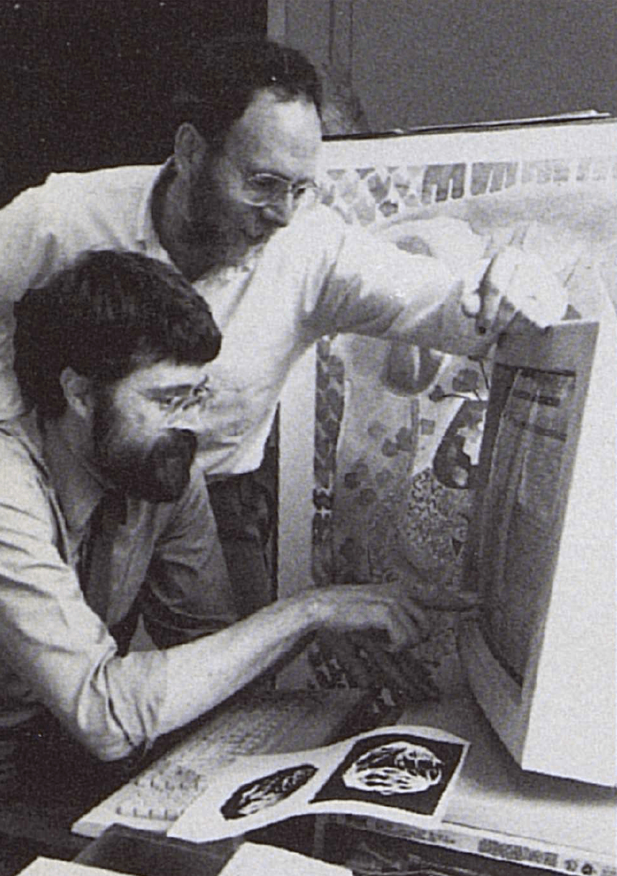 Two men at a 1990's desktop computer