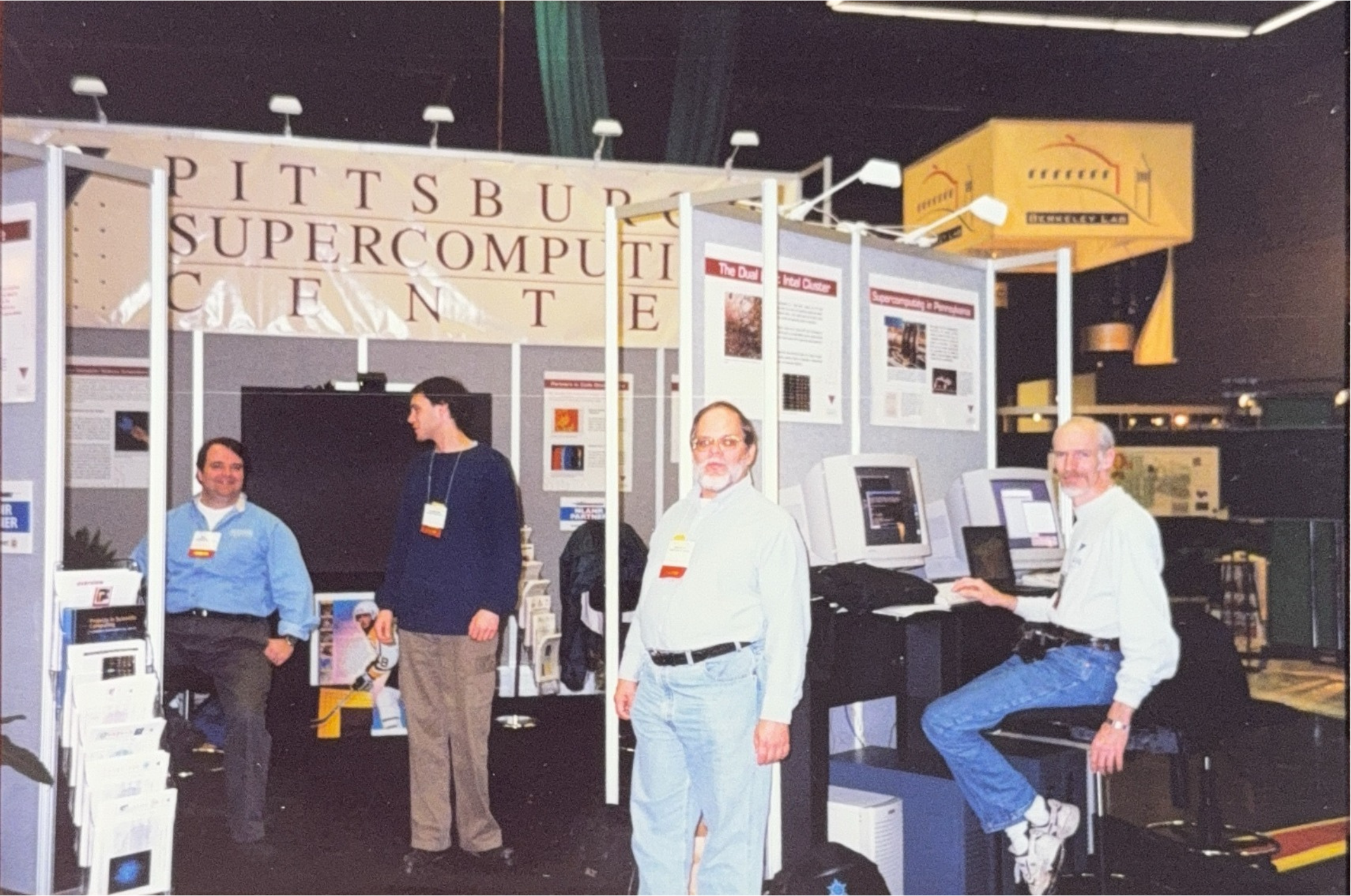 Four people at the PSC booth at the Supercomputing Conference.